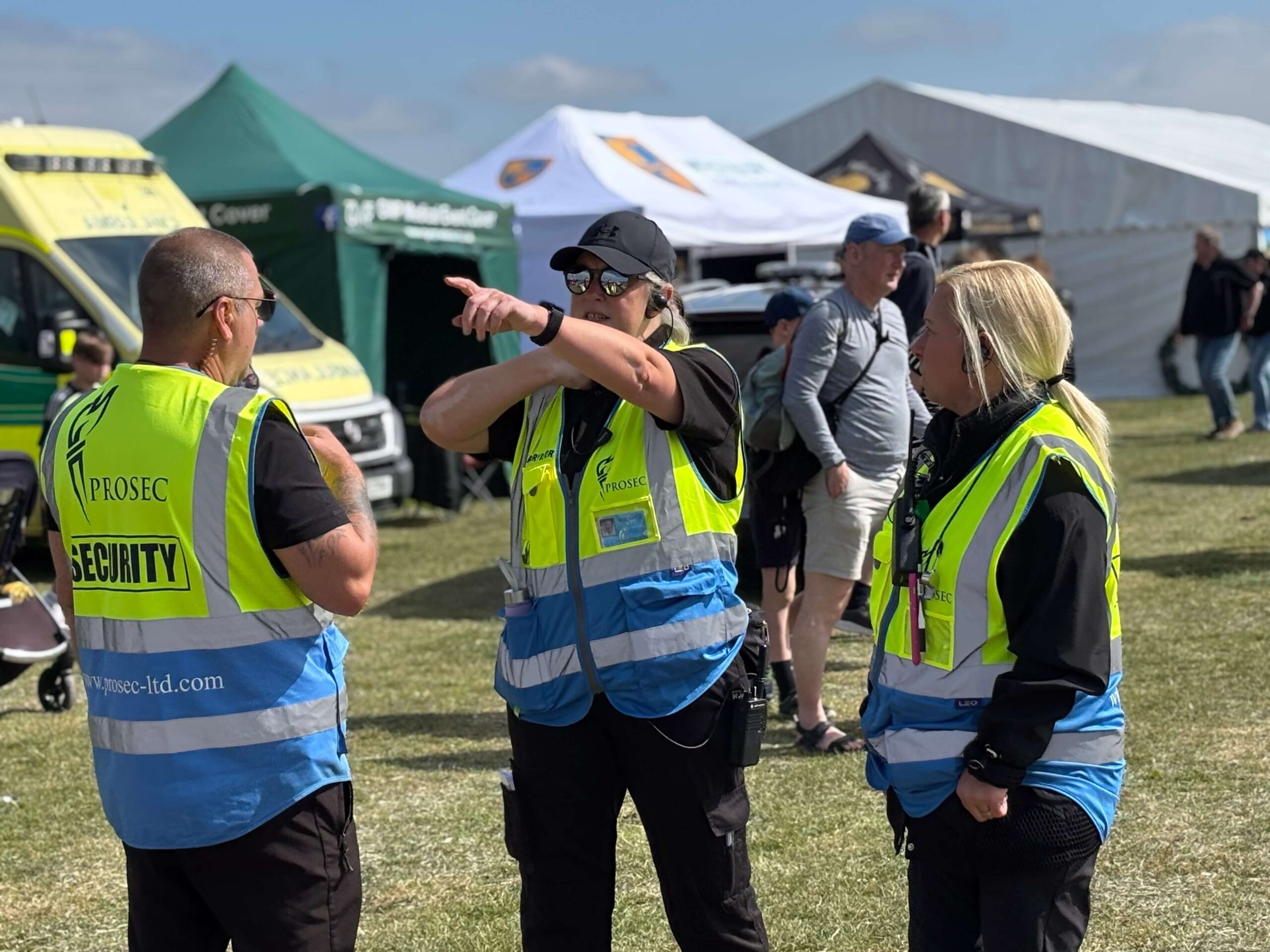 3 members of prosec team working security at a festival event.